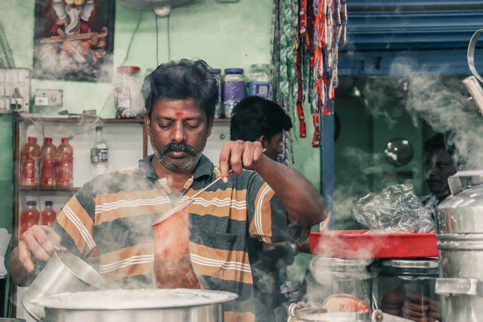 Chai vendor preparing masala chai at a street stall